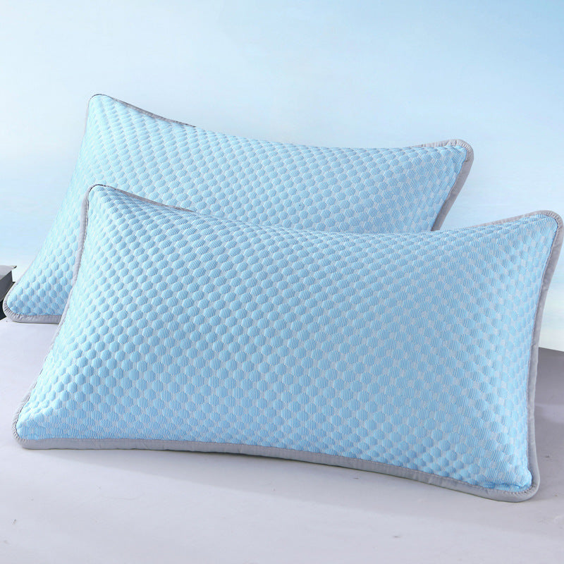 Two blue pillows with a textured pattern on a light background