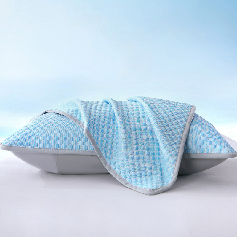Blue quilted pillow on a light blue background
