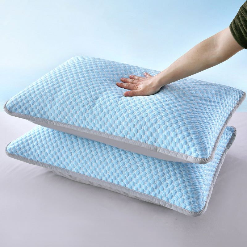 Two blue pillows with a hand touching one of them on a light gray background