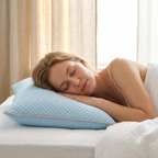 A woman sleeping peacefully on a light blue quilted pillow on a bed with white sheets, set against a soft background of beige curtains and a bright window.
