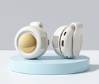 Two small round white electronic devices with a gold reflective center and vented sides, displayed on a light blue pedestal against a light gray studio background.